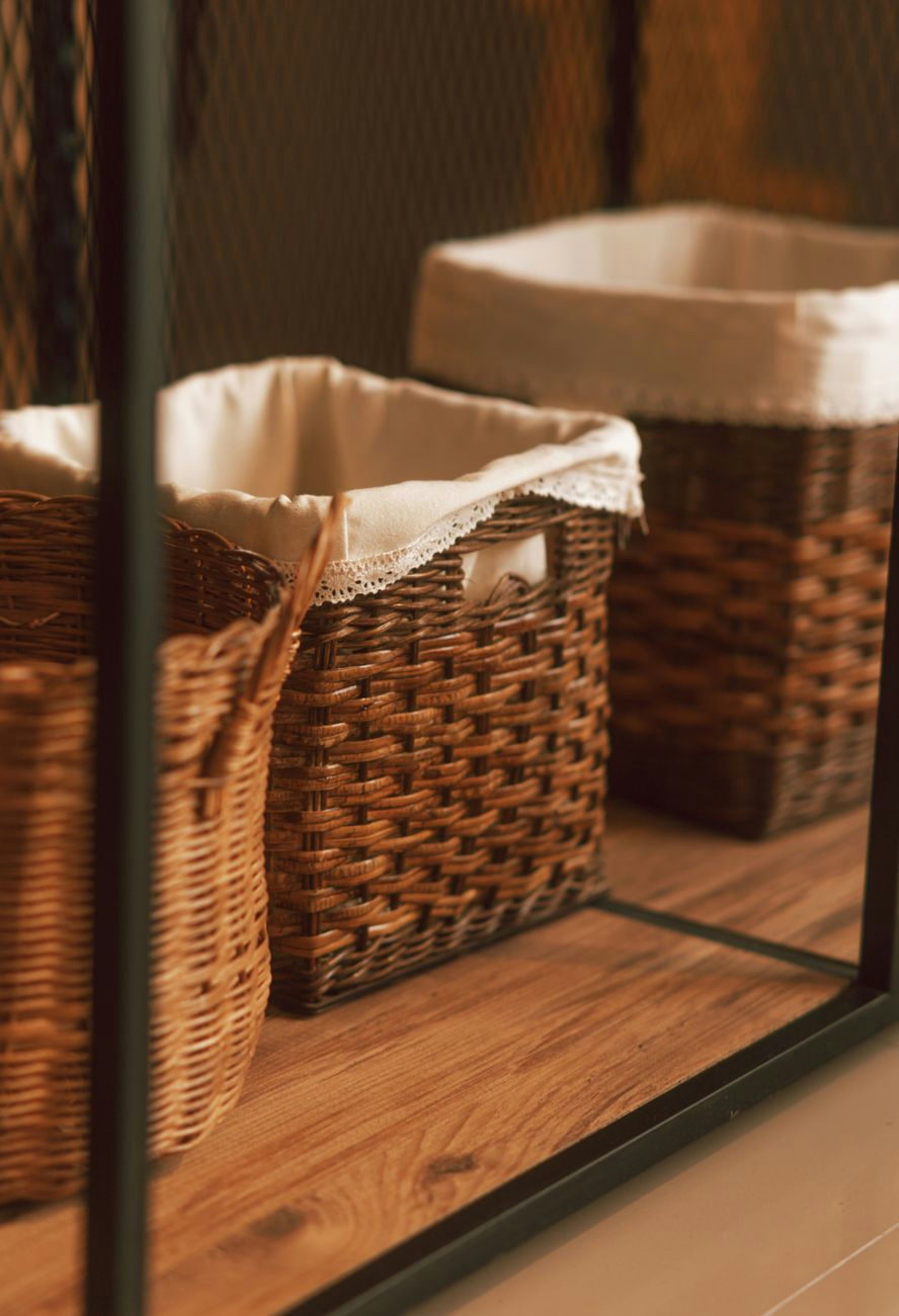 Cozy wicker storage baskets lined with cloth in a warm-toned indoor setting. Ideal for home decor.