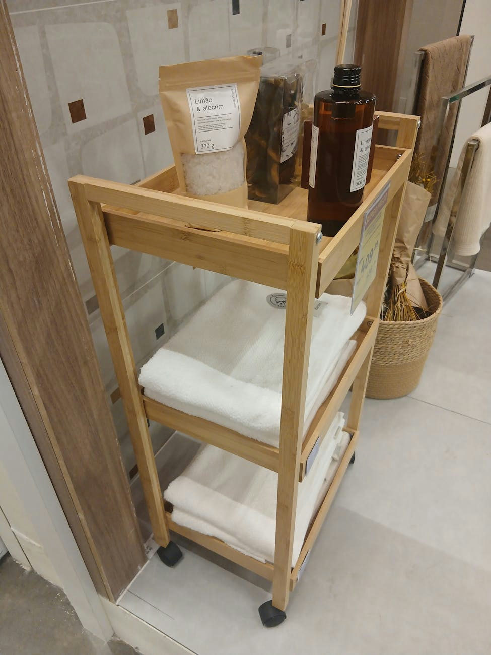 Elegant wooden bathroom cart with towels and bath products neatly arranged.