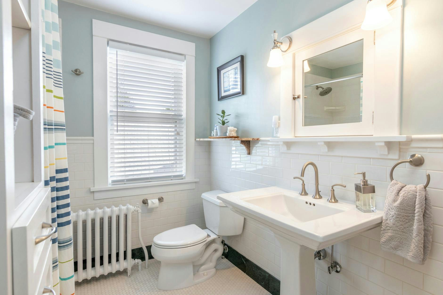 A clean and modern bathroom with white fixtures and natural lighting.