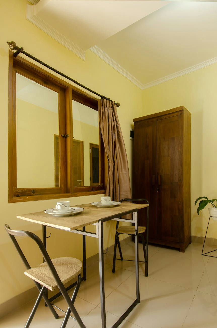 A simple and warm dining area featuring wooden furniture and natural lighting.