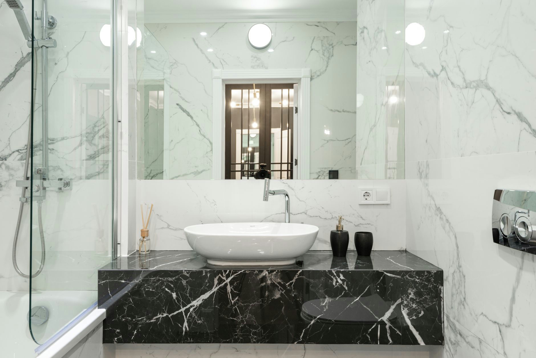 Elegant marble bathroom featuring modern sink and fixtures.